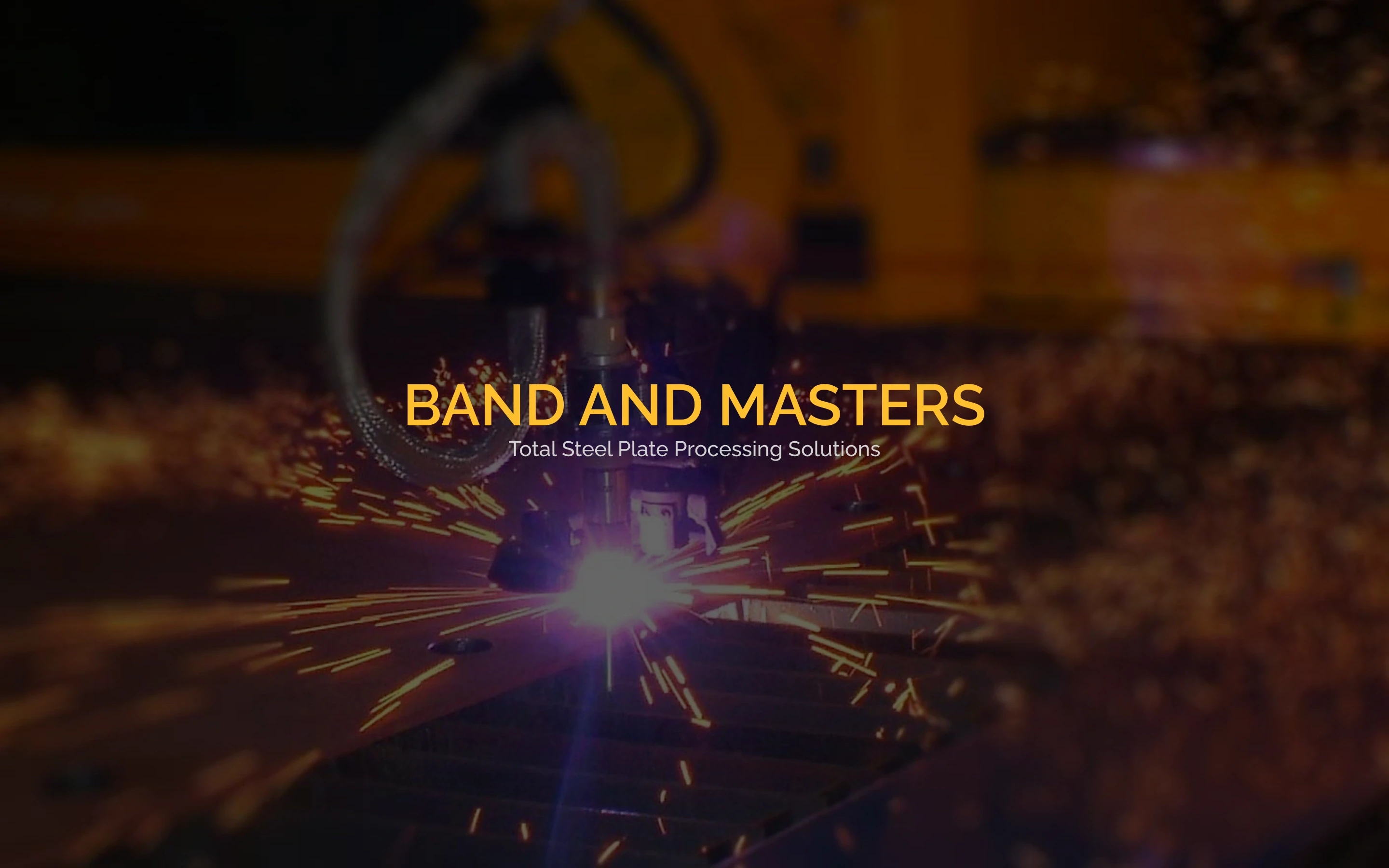 Band and Masters homepage with yellow branding over a steel-cutting machine throwing sparks.