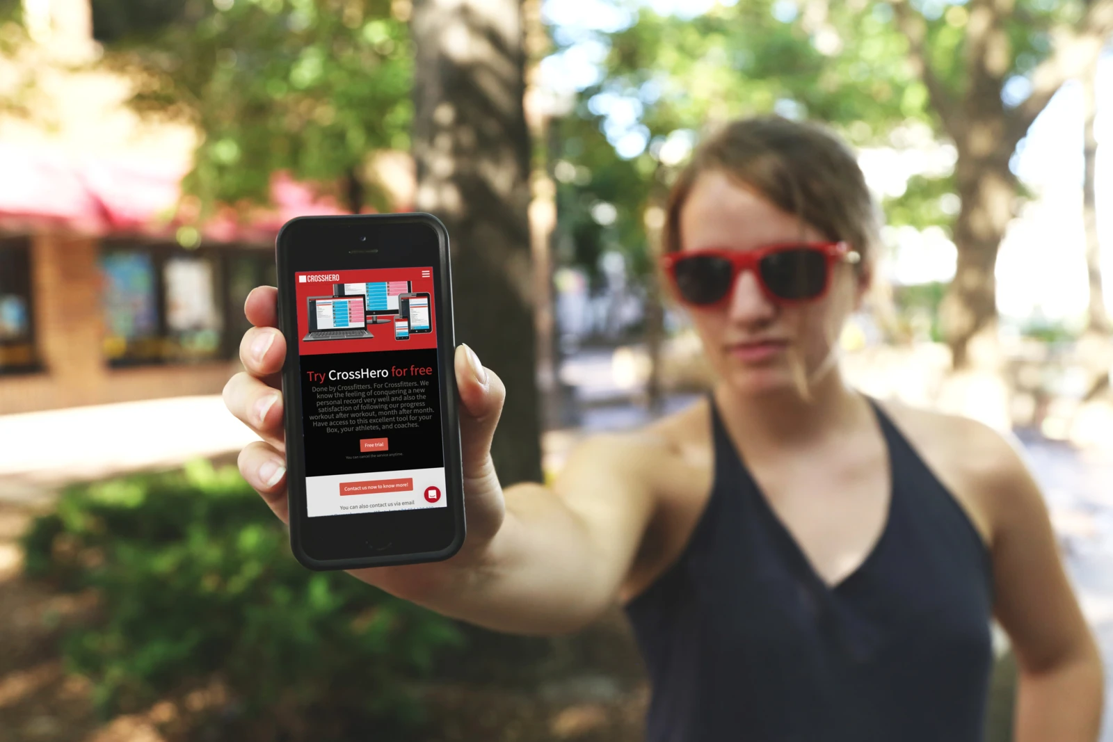 CrossHero’s mobile website displayed on a phone held outdoors.